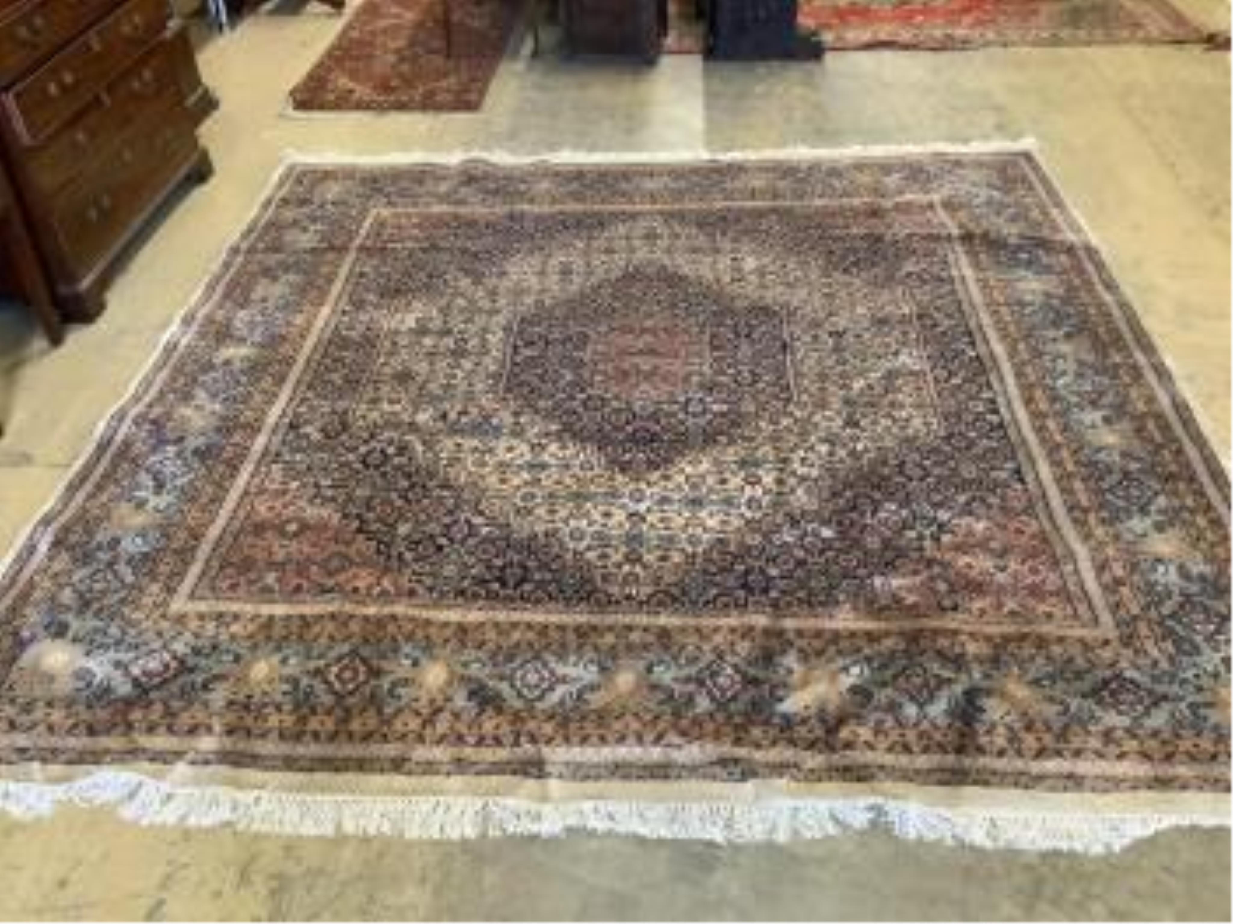 A pair of North West Persian ivory ground carpets, each 294 x 299cm. Condition - fair